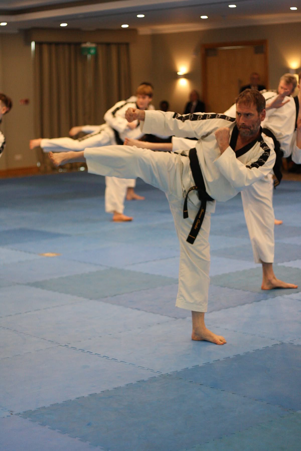 Corsham Tae Kwon Do black belt performing a side kick during class